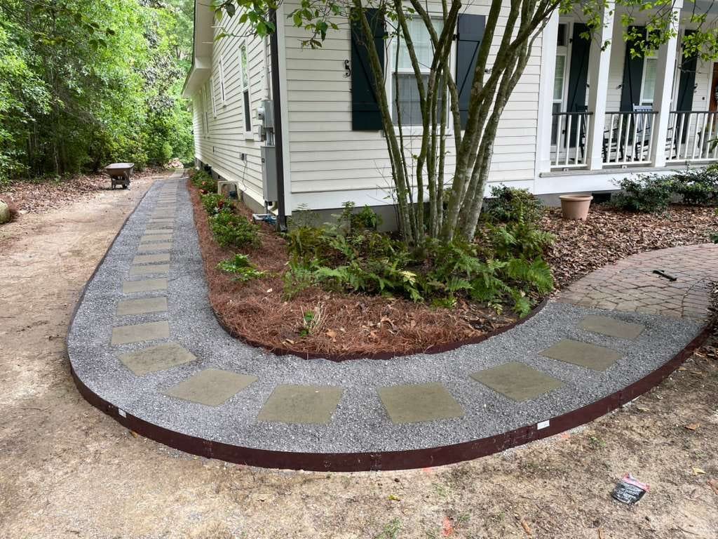 Curved stone walkway and mulch bed landscaping by Binder's Landscapes